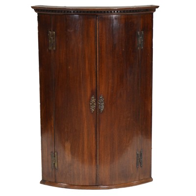 Lot 437 - George III mahogany bowfront hanging corner cupboard
