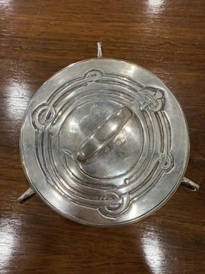Lot 135 - Archibald Knox for Liberty & Co., a Cymric silver muffin dish and cover, 1902