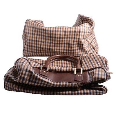 Lot 553 - Aquascutum - two similar travel bags in traditional Aquascutum print in coated canvas with leather trim.