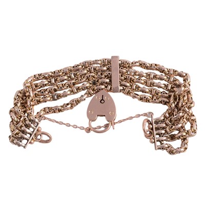 Lot 197 - A yellow metal five row chain link bracelet. with padlock fastener.