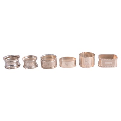 Lot 320 - Thirteen silver napkin rings, and two metal napkin rings.