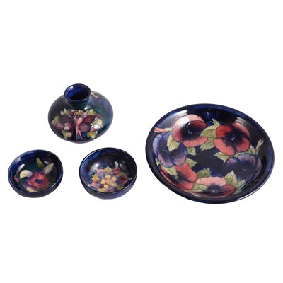 Lot 7 - Moorcroft Pottery, 'Pansy' pattern plate, 1920s, and three other pieces