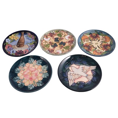 Lot 8 - Moorcroft Pottery, four Year Plates and another plate