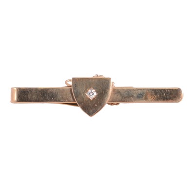 Lot 377 - A 9 carat yellow gold tie bar set with a diamond.