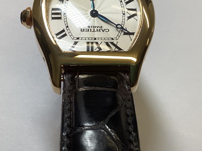 Lot 1004 - Cartier - a Tortue 18 carat yellow gold manual wind wristwatch.