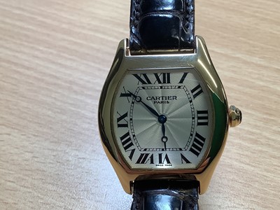 Lot 1004 - Cartier - a Tortue 18 carat yellow gold manual wind wristwatch.