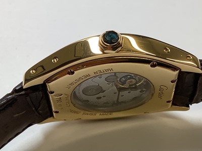 Lot 1004 - Cartier - a Tortue 18 carat yellow gold manual wind wristwatch.