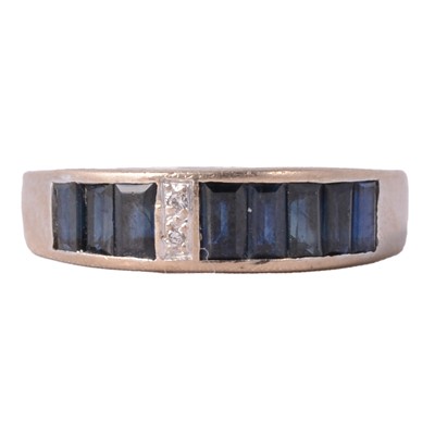 Lot 40 - A sapphire and diamond half eternity ring.