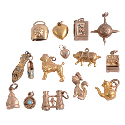Lot 186 - Fourteen yellow gold / yellow metal charms, and a gilt metal charm.