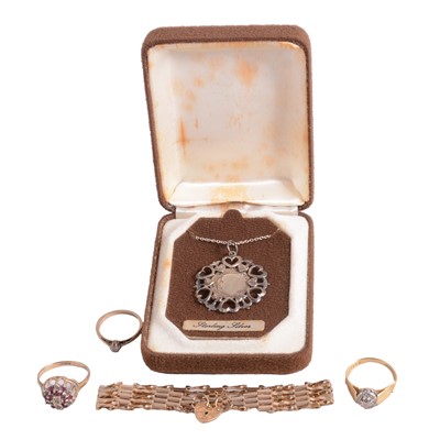 Lot 162 - A 9 carat yellow gold bracelet, three gold gemset rings, and a silver coin pendant on a chain.