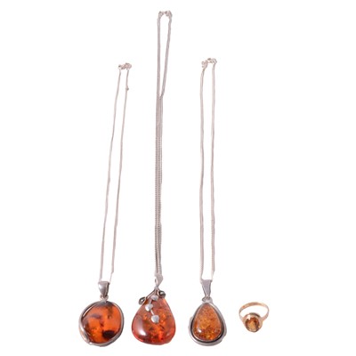 Lot 429 - A citrine ring, three pieces of amber jewellery.