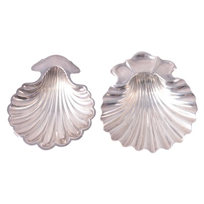 Lot 242 - Two silver shell design butter dishes