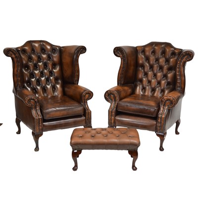 Lot 425 - Pair of leather wing back armchairs and a footstool