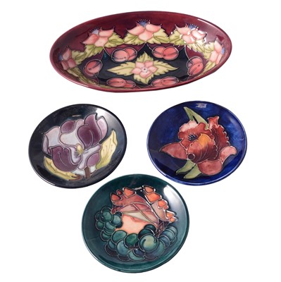 Lot 2 - Moorcroft Pottery, three coasters and an oval dish