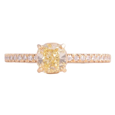 Lot 67 - Tiffany - a "Tiffany True" yellow diamond solitaire ring with white diamond shoulders.