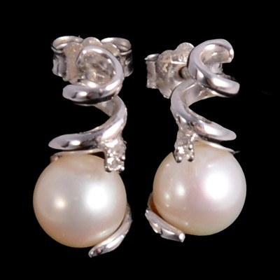 Lot 258 - A pair of pearl and diamond earrings.