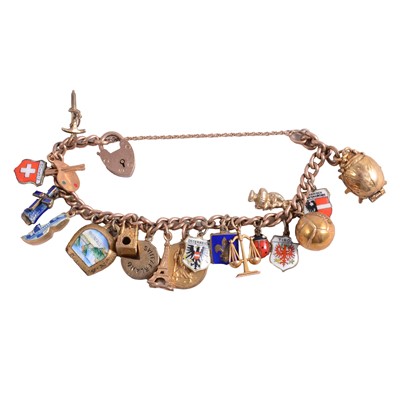 Lot 181 - A rose metal curb link bracelet with gold, silver and metal charms.