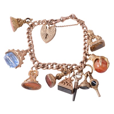 Lot 178 - A 9 carat gold bracelet with nine seals, fobs and watch keys.