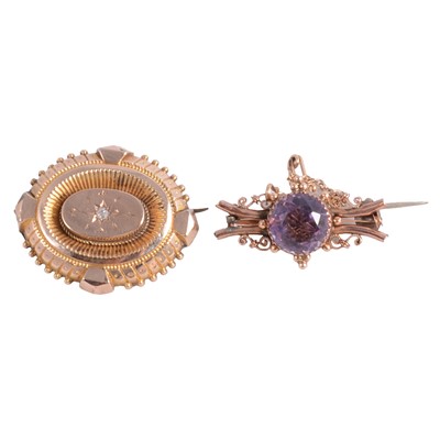 Lot 233 - A Victorian oval target brooch and an amethyst brooch.