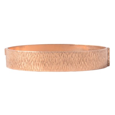 Lot 212 - A 9 carat yellow gold solid half hinged bangle.