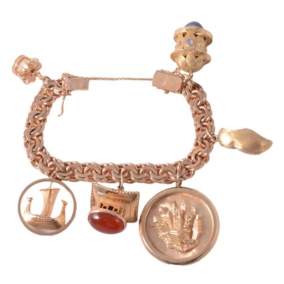 Lot 177 - A yellow metal charm bracelet with six charms.