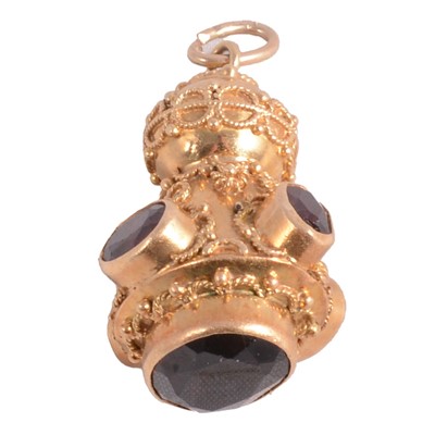 Lot 264 - An Italian Etruscan revival charm/pendant, circa 1970's, set with garnet.