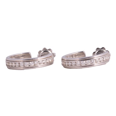 Lot 321 - A pair of diamond hoop earrings.