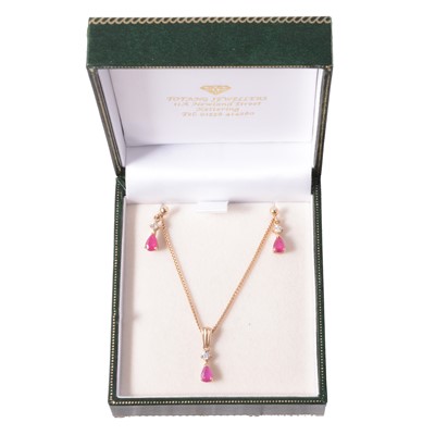 Lot 256 - A ruby and diamond pendant and earrings suite of jewellery.
