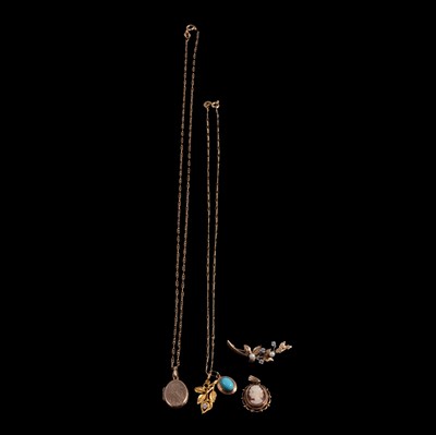 Lot 275 - A collection of pendants and chains and a leaf brooch.