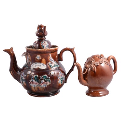 Lot 27 - Two Measham Bargeware teapots, Cadogan teapot, Brown Betty teapot and a sprig teapot., teapot stand