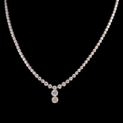 Lot 292 - A diamond riviere necklace with a two stone diamond drop.