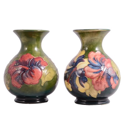 Lot 1 - Walter Moorcroft for Moorcroft - a near pair of Hibiscus green ground vases
