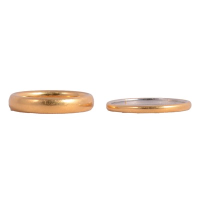 Lot 135 - A 22 carat gold wedding band, and a yellow and white metal wedding band.