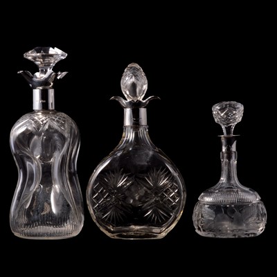 Lot 304 - Three silver mounted cut glass decanters