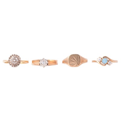 Lot 113 - Two solitaire rings, a signet ring and three stone crossover ring.