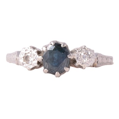 Lot 37 - A sapphire and diamond three stone ring.