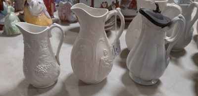 Lot 39 - Nine white stoneware jugs