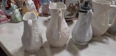 Lot 39 - Nine white stoneware jugs