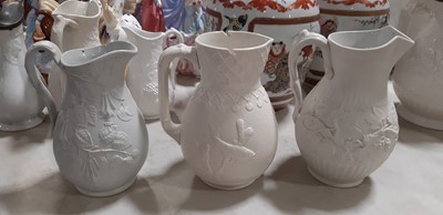 Lot 39 - Nine white stoneware jugs