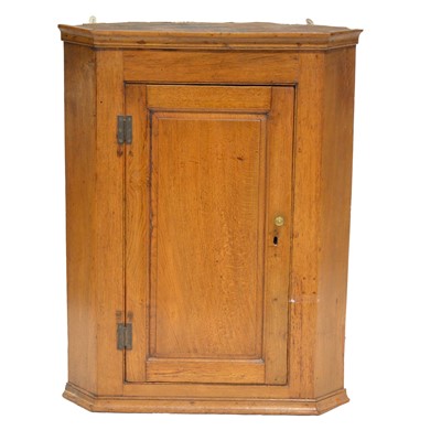 Lot 415 - George III oak hanging corner cupboard