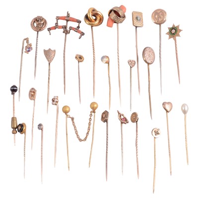 Lot 355 - Twenty-six gold / yellow metal stick pins, some gemset, some with metal pins.