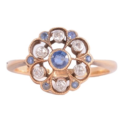 Lot 33 - A sapphire and diamond cluster ring.