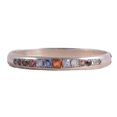 Lot 428 - A silver half hinged bangle bespoke set with various gemstones.