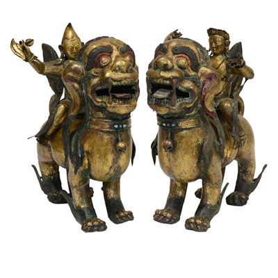 Lot 32 - Pair of 18th century Tibetan repousse copper snow lions with deities