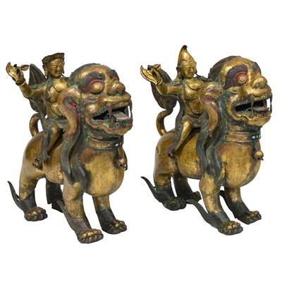 Lot 32 - Pair of 18th century Tibetan repousse copper snow lions with deities