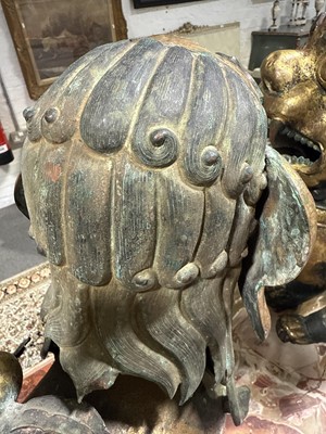 Lot 32 - Pair of 18th century Tibetan repousse copper snow lions with deities