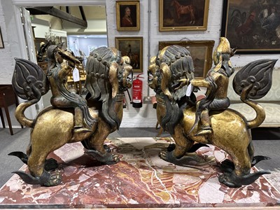 Lot 32 - Pair of 18th century Tibetan repousse copper snow lions with deities
