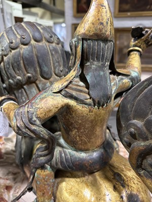 Lot 32 - Pair of 18th century Tibetan repousse copper snow lions with deities
