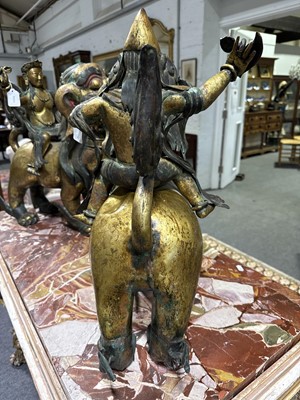 Lot 32 - Pair of 18th century Tibetan repousse copper snow lions with deities