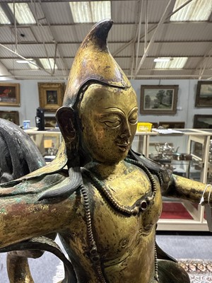 Lot 32 - Pair of 18th century Tibetan repousse copper snow lions with deities